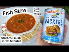 a person holding a can of chicken stew next to a white plate with crackers