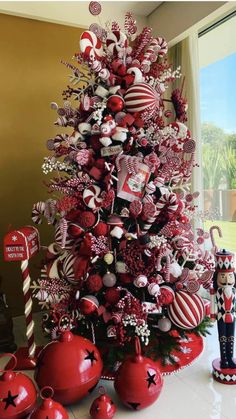 a christmas tree decorated with ornaments and candy canes in red, white and black