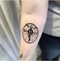 a person's arm with a tattoo on it and an arrow in the middle