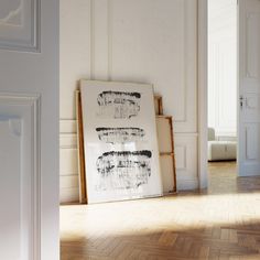 an empty room with white walls and wooden floors