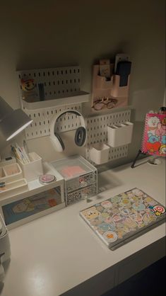 an office desk with various items on it and a lamp in the corner next to it