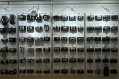 there are many cameras on display in this room