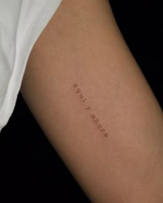 a woman's arm with the word love written on it, in cursive font