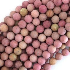 pink and brown beads are stacked on top of each other, with one bead in the middle