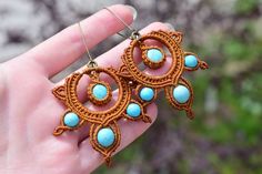 These stunning macrame earrings in warm brown tones are the perfect accessory for any boho lover. Handcrafted with care and attention to detail, these earrings feature a unique round design adorned with beautiful turquoise beads fashioned into delicate petals. The intricate macrame technique adds a beautiful texture and dimension to the piece, making it truly one-of-a-kind. The warm brown color of the macrame cord perfectly complements the bright turquoise beads, creating a harmonious and eye-catching contrast. These earrings are perfect for any occasion, whether you're dressing up for a special event or adding a touch of boho flair to your everyday look. With their lightweight and comfortable design, you'll love wearing them all day long. These macrame earrings would make a wonderful addi Intricate Macrame, Bright Turquoise, Macrame Earrings, Brown Tones, Macrame Cord, Round Design, Warm Brown, Creative Jewelry, Beautiful Textures