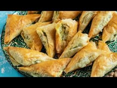 there are many pastries on the plate and one is cut in half to show it's filling