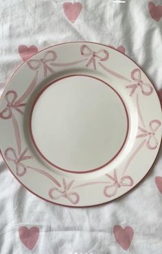 a white plate with pink bows and hearts on the tablecloth is ready to be eaten