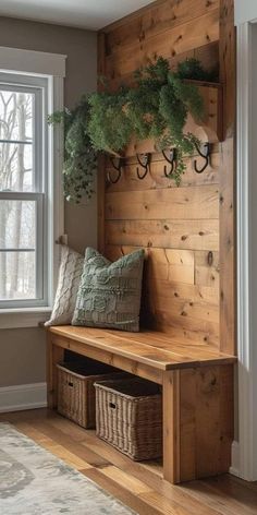 a wooden bench with some plants on it and two baskets under the bench next to it