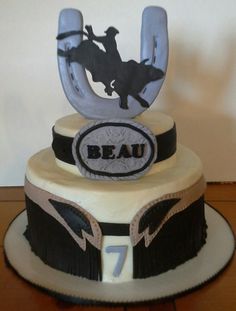 a birthday cake with the number seven on it and an image of a cowboy riding a horse