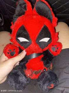 someone is holding a deadpool stuffed animal