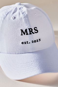 a white hat with the words mrs estt 2055 printed in black on it