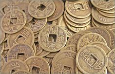 a pile of gold coins with chinese writing on them