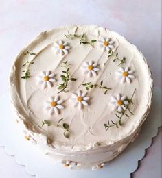 a cake with white frosting and flowers on it