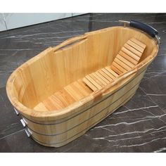 a large wooden bathtub sitting on top of a marble floor