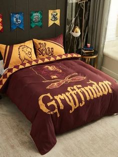 a bed with harry potter comforter and pillows