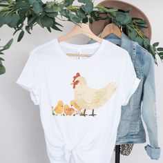 This classic unisex jersey short sleeve tee fits like a well-loved favorite. Soft cotton and quality print make users fall in love with it over and over again. It makes a great gift for the chicken lover in your life!  .: Light fabric  .: Retail fit .: Tear away label .: Runs true to size Pre-shrunk Family Matching Tops For Spring, Spring Family Matching Crew Neck T-shirt, White Tri-blend Top With Funny Print, White Soft-washed Top For Mother's Day, Chicken Birthday Shirt, Funny White T-shirt For Spring, Family Matching Summer T-shirt With Screen Print, Family Matching Screen Print T-shirt For Summer, Family Matching Soft-washed Summer T-shirt