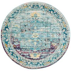 a round rug with an ornate design in blue, pink and yellow colors on the inside