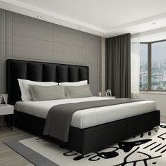 a bedroom with a bed, rug and window overlooking the cityscape in black and white