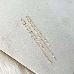 Our Alondra Threader Earrings are dainty chain thread earrings with a square cut cubic zirconia. Minimalist and simple but with a bit of bling, these earrings are perfect for every day wear and adding a little bit of glam to your outfit. 925 Silver + gold plating. Water resistant. Best practice is to keep away from moisture to keep the gold plating last long. Length: about 3in. Threader Earrings Gold, Face Gems, Ear Jacket Earring, Thread Earrings, Dainty Chain, Ring Sale, Best Practice, Threader Earrings, Square Cut