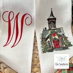 two white towels with red and green designs on them