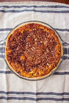 a pie sitting on top of a table covered in nuts