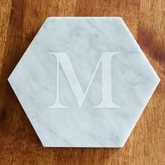 a marble coaster with the letter m on it