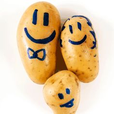 three potatoes with faces drawn on them