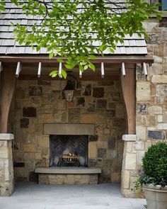 an outdoor fireplace in the middle of a patio