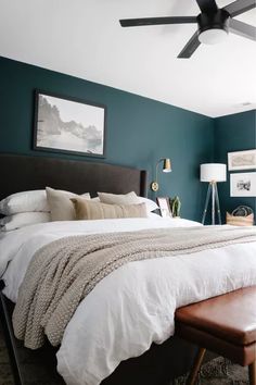 a bedroom with green walls and white bedding