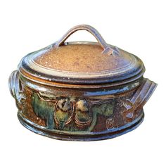 an ornately decorated metal container with handles