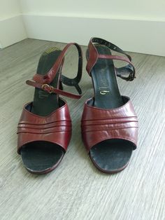 Very chic pair of vintage strappy sandals with heels. Reddish burgundy color. Brand: Naturalizer Size: 9 Measurements are approximately: Insole length: 10 1/8" Width: 3 1/8" Heel height: 3" Good used vintage condition with signs of wear due to use and age. They do have some scuffs and marks. Weight: 345 g Burgundy Sandals, Sandals With Heels, Vintage Shoes Women, Burgundy Color, Vintage Shoes, Strappy Heels, Strappy Sandals, Womens Heels, Gladiator Sandals