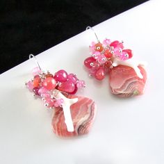 I love these focals! They are Argentine rhodochrosite gems and measure 22x20mm. They have been wrapped in sterling silver wire and dangle below a gorgeous combination of smooth ruby briolettes, pink moonstone, pink sapphire, white branch coral. Each bead is meticulously wrapped onto it's own head pin. The entire cluster is topped. I have used simple sterling ear wires. The earrings measure 1 3/4 (44mm.) from the top of the ear wires. White Branches, Black Freshwater Pearls, Pink Moonstone, Peacock Pearl, Green Opal, Aquamarine Stone, Gold Filled Earrings, Blue Quartz, Head Pins