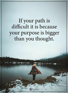 a person standing in front of a lake with a quote on it that says, if your path is difficult it is because your purpose is bigger than you thought