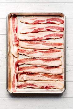 raw bacon on a baking sheet ready to be cooked