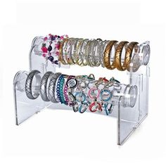 a rack with rings and bracelets on it for display in a store or office