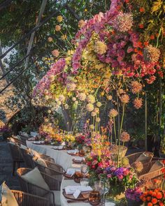 an outdoor dining area with tables covered in flowers