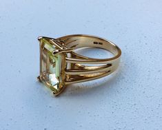 The past will always return in the fashion world and this piece is back for round two! In the 1920's ladies of class wore the most opulent dresses with jewelry to match. As the years continued, jewelry makers tailored pieces to fashion and trends which resulted in affordability for style. Presenting this Absolutely Stunning Vintage 14k Gold Emerald Cut 15 Carat Laguna Yellow Citrine Solitare Ring Featuring Elegant Oversized Design. Approximate Size: Ring Size 6 and Stone Measures 15 mm by 10 mm Vintage Yellow Gold Jewelry With Rectangular Stone, Yellow Rectangular Gemstone Rings, Yellow Rectangular Gemstone Jewelry, Luxury Yellow Emerald-cut Jewelry, Vintage Yellow Citrine Jewelry, Mens Gemstone Rings, Yellow Citrine, Bow Earrings, Emerald Cut