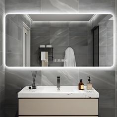 a bathroom with a sink, mirror and soap dispenser on the counter