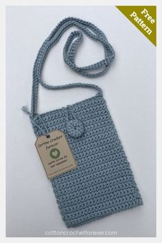 a blue crocheted cell phone case with a tag on the front and side