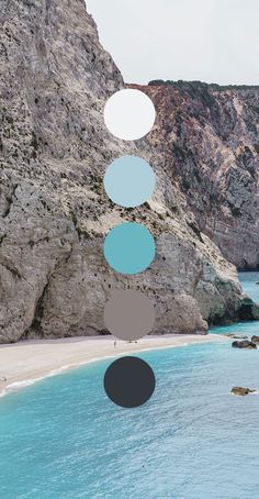 an image of a beach with rocks and blue water in the foreground that has circles above it