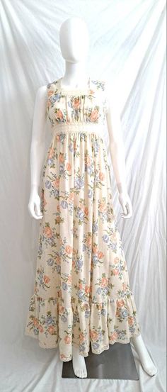 Just the prettiest long floral maxi Prairie dress by Rag Dolls. Circa 1970s Gauzey floral print maxi with sheer lacey inset at empire waist. Background is a cream color with peach and blue flowers Cotton Blend Bust 32 Empire waist 26 Hips open 55 inch total length from shoulder to hemline. Sturdy and I see no holes or tears. Lace in excellent condition. Some stains but they blend into the fullness of fabric. Underarms have discoloration. I have not tried to remove stains. They may lighten or com Floral Cottagecore, Rag Dolls, Prairie Dress, Floral Print Maxi, Lace Inset, Sleeveless Maxi Dress, Floral Maxi, Sheer Lace, Dress Clothes For Women