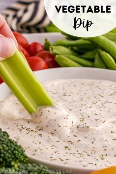 a person dipping dip into a bowl with vegetables in the background and text overlay that reads, how to make vegetable dip