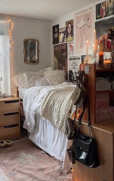 a bed room with a neatly made bed and lots of clutter on the walls