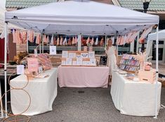 an outdoor market with pink and white decorations