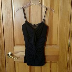 95% Polyester, 5% Spandex Blackspaghetti Strap Top. Lining Is 100% Polyester. Gathered Seam Going Down The Front With A Ruffle. Lace Panel In The Back With An Elastic Gathered Seem Going Down From The Lace. Fitted Cami For Evening Wear, Fitted Evening Cami, Black Stretch Camisole For Night Out, Stretch Black Camisole For Night Out, Flirty Fitted Tops With Adjustable Straps, Fitted Black Camisole For Night Out, Fitted Cami Intimate For Evening, Flirty Fitted Camisole With Adjustable Straps, Flirty Fitted Camisole