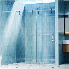 a bathroom with blue tile walls and flooring, including a walk in shower next to a toilet