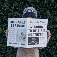 a person holding up a newspaper with an article on it