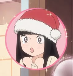 a woman wearing a santa hat in front of a mirror