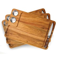 three wooden cutting boards with metal handles