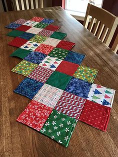 the table is set with four different pieces of quilted fabric on top of each other